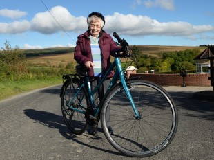 Cycle Sperrins 13th October 2015 Annie Slane, 90 year old resident and Cyclist in the Broughderg Area, at the launch of t he Cycle Sperrins Consortium, which is made up of speciality food producers, farm businesses, tearooms and quality accommodation providers based along the world-class four day cycle route, welcomes Tourism NI chairman, Terence Brannigan, to officially launch Cycle Sperrins. Picture Oliver McVeigh - For further information contact Eleanor McGillie at MGMPR Ltd - PR Northern Ireland .